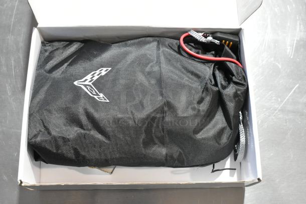 Battery tender GM 85530676 for C6, C7, C8 Corvettes, in black nylon bag with Corvette logo, includes charger cables.