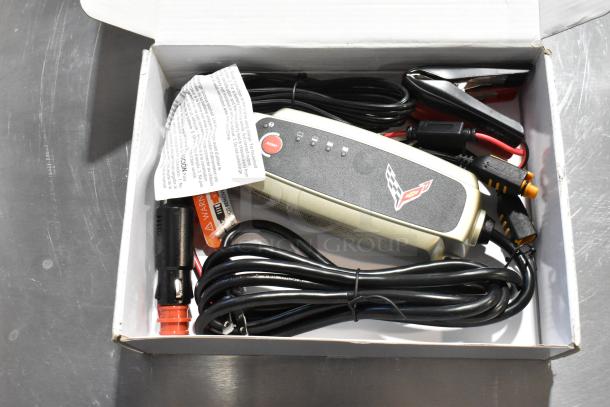 GM 85530676 Battery Tender for C6, C7, C8 Corvettes in box with cables, instructions visible. GM Accessories branding.