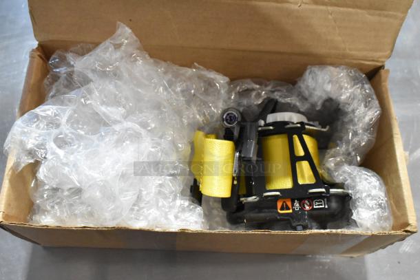 GM 85557292 yellow seat belt in box with bubble wrap, new condition, visible warning labels, durable material.