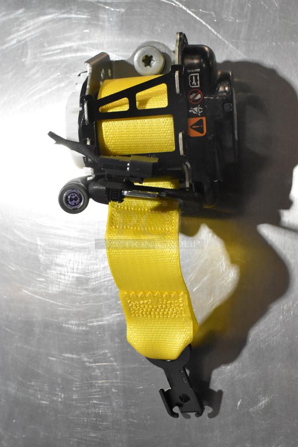 GM 85557292 yellow seat belt with black hardware, new condition, safety labels visible.