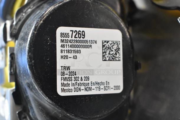 GM 85557292 yellow seat belt with visible TRW label, made in Mexico, FMVSS 302 & 209 compliant.