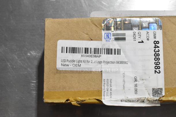 Box with LED Puddle Light Kit, new OEM, featuring logo projection. Item number 84388982, GM label visible.