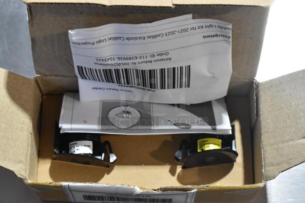 Box containing LED Puddle Light Kit, with papers and barcodes visible, part of a 5-item auction package.