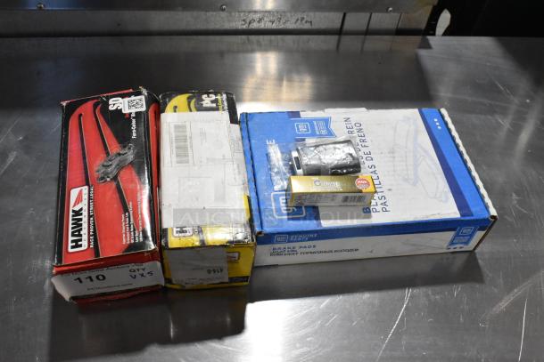 5 automotive items: NGK BKR5EGP bulb, Hawk HB639 Z.645 ceramic brake pad, Hawk HB556 P.710 HP SuperDuty, GM brake pads.