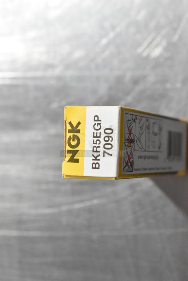 NGK BKR5EGP 7090 bulb box, clearly labeled with installation warnings, in pristine condition.