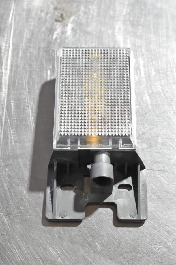 GM brake light piece, model 25664746, features durable plastic and clear textured lens, part of a 4-item auction lot.