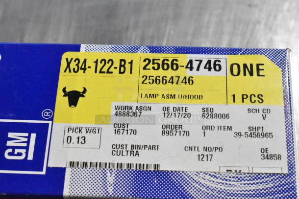 Box labeled "X34-122-B1", "GM 25664746", for a GM lamp assembly. Includes order and pick weight details.