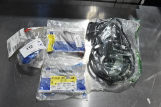 Four various GM automotive parts, including GM X21-116-D1 and GM reflector part, in original packaging with labels.