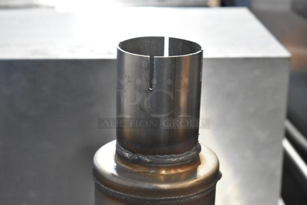 Magnavox MF exhaust in metal, featuring a cylindrical design and welding details, part of an auction item bundle.