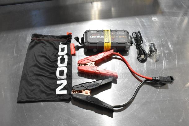 Noco GB40 Genius Boost jump starter with clamps, USB cable, and pouch. Includes Magnavox MF Exhaust, condition unknown.
