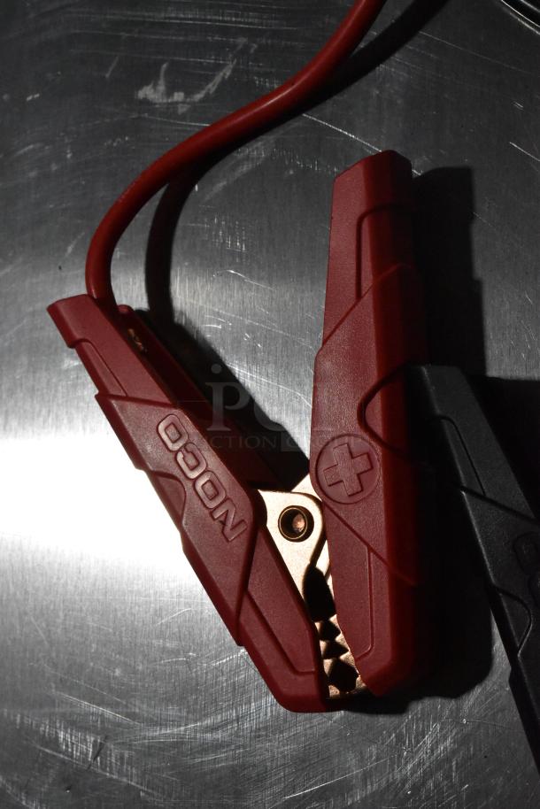 Noco GB40 Genius Boost jump starter clamp; red grip with "NOCO" branding, in excellent condition.