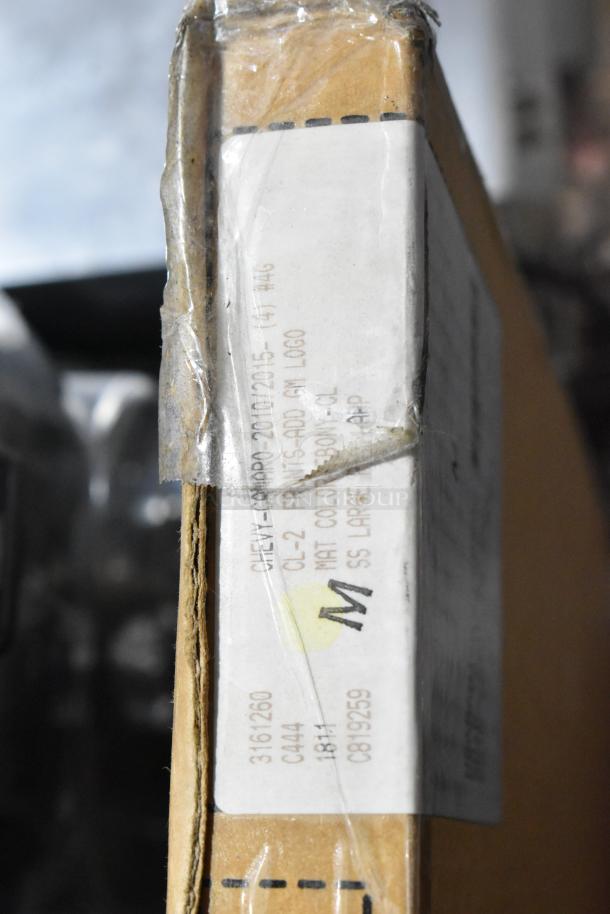 Cardboard box with visible label showing item code and details. Contains scratch and dent items like Corvette and Porsche floor mats.