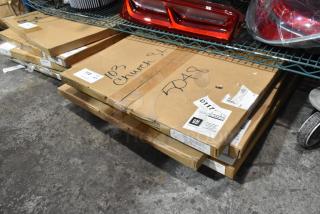 Five new boxed items on wire rack, including Corvette and Silverado floor mats. Boxes show GM labels and scratch markings.