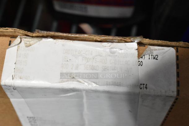 Cardboard box with label reading "Cadillac-CT4," indicating front and second seat floor mats with Cadillac logo, in black VT.