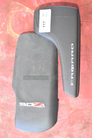 Two Camaro pads, black with embroidered logos; one marked "CAMARO" and the other "Z06." Tag labeled "117."