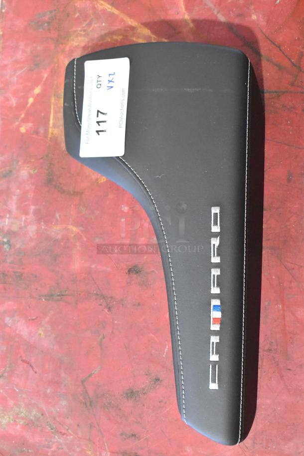 Black Camaro pad with white stitching and logo, item tag 117, on red background.