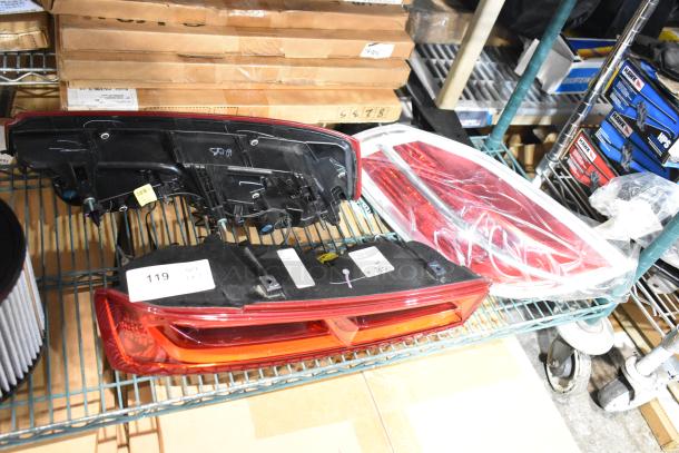 Three brake lights, new condition, on shelves with labels indicating item number.