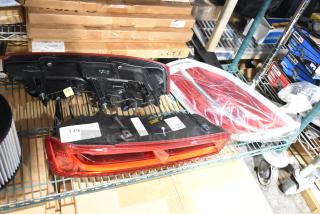 Three brake lights, new condition, on shelves with labels indicating item number.