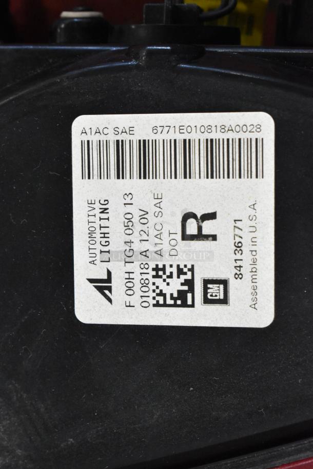 Label displaying item details including "Automotive Lighting," model F00H TG4 050 13, 12V, GM part number 84136771. Assembled in USA.
