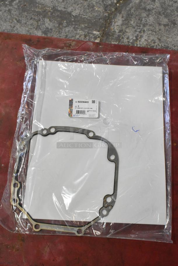 Package contains GM 92230403 gasket, sealed in plastic. White label indicates part details and condition.