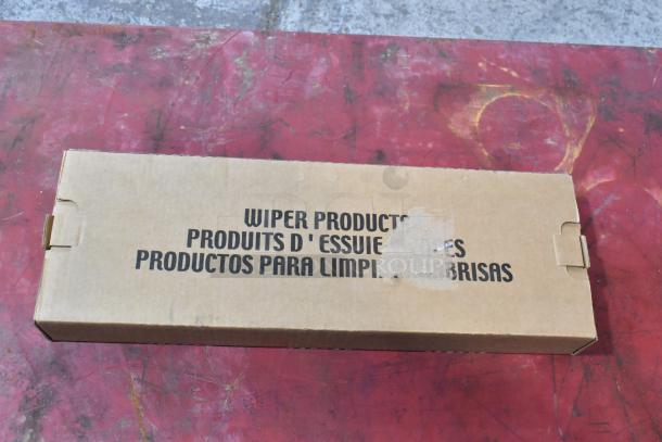 Cardboard box labeled "Wiper Products" containing GM 23360288 wiper blade, unopened, on a red surface.