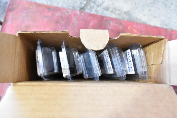 Cardboard box containing various packaged items, including GM 23360288 wiper blade, view of labels and packages inside.