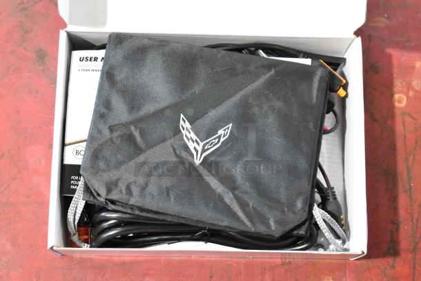 GM 85530676 Battery Tender for C6, C7, C8 Corvettes, with cords and user manual in box. Includes logo pouch. New condition.