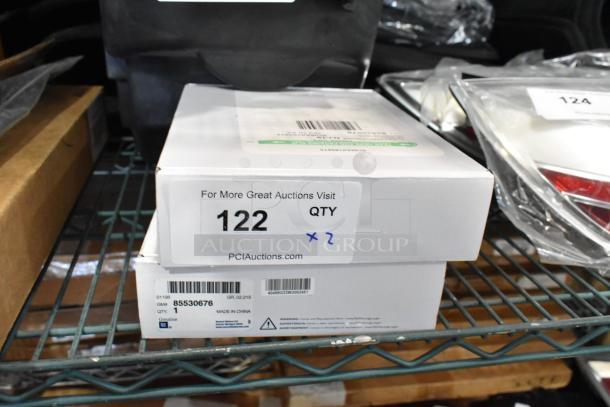 GM 85530676 Battery Tender for C6-C8 Corvettes, new in box, quantity 2. Barcode and PCI Auctions label visible.