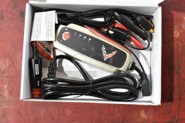 GM 85530676 Battery Tender for C6, C7, C8 Corvettes, new in box, with cables and instructions, Corvette logo visible.