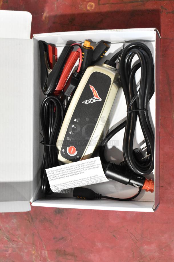 GM 85530676 Battery Tender for C6, C7, C8 Corvettes in open box, new condition, with cables and instruction tag.