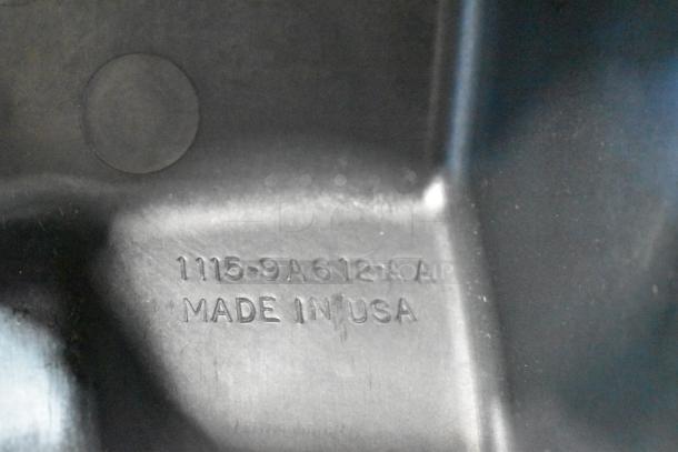 Metal part with embossed marking "1115-9A612-AA Made in USA," part of a lot including 997-951F filter for auction.