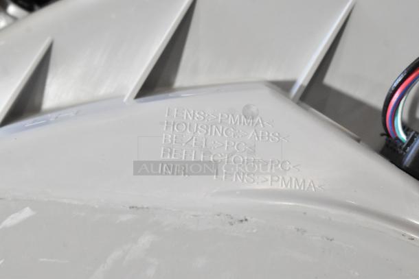 Brake light showing material markings: Lens PMMA, Housing ABS, Bezel PC, Reflector PC, in excellent condition.