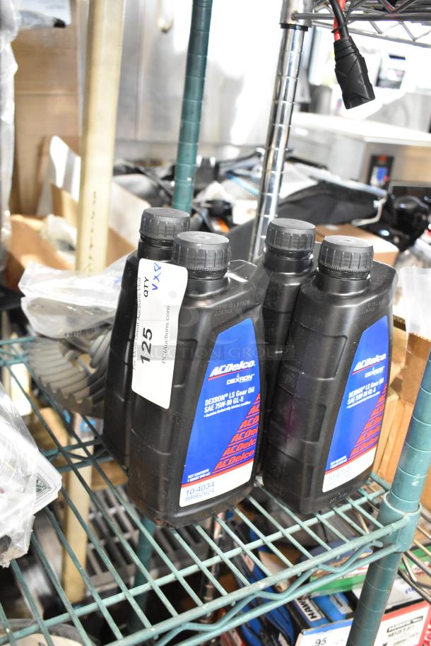 ACDelco gear oil bottles on shelf, labeled for auction. Includes various parts. Quantity: 8. Condition: appears new.