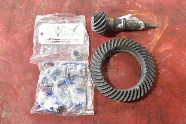 8 various automotive parts, including ACDelco gear, ring gear, and packaged small parts; some labeled with GM stickers.
