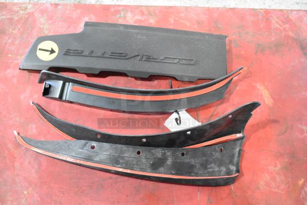 Assorted items on red surface, includes Z71 Off Road emblems and black plastic components. Some wear visible.