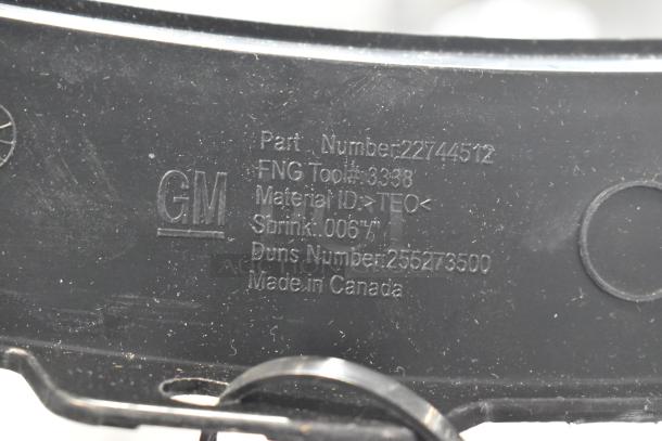 Close-up of GM part with inscriptions showing part number 22744512, material ID TEO, made in Canada.