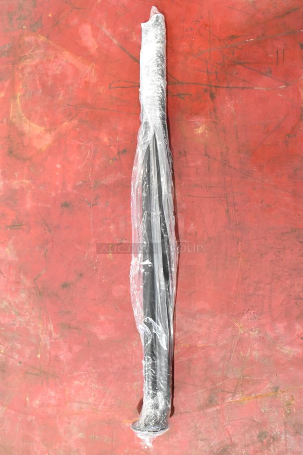 Packaged cylindrical item in plastic wrap on red surface; part of a set with Z71 Off Road emblems, unassembled condition.