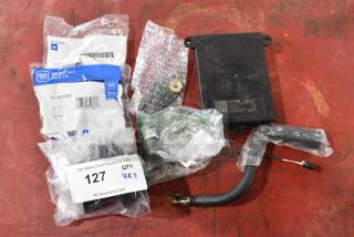 Seven various GM parts in packaging, including GM 22751230 door latch release switch and GM 20959449 rear suspension stabilizer shaft clamp.