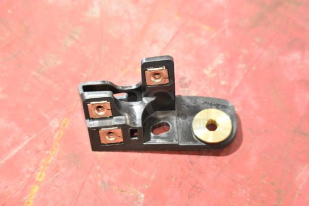 GM 22751230 door latch release switch. Black with gold detail. Visible markings, indicating model number. Auction bundle item.