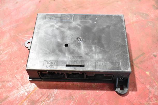 7 automotive parts including GM 22751230 door latch release switch, GM 20959449 stabilizer shaft clamp. Marked "GRAY" and "BLACK."