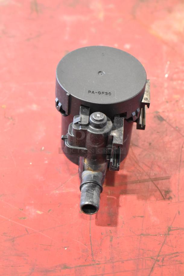 Car part with marking "PA-GF30," likely part of a lot with GM parts, including a door latch release switch and stabilizer shaft clamp.