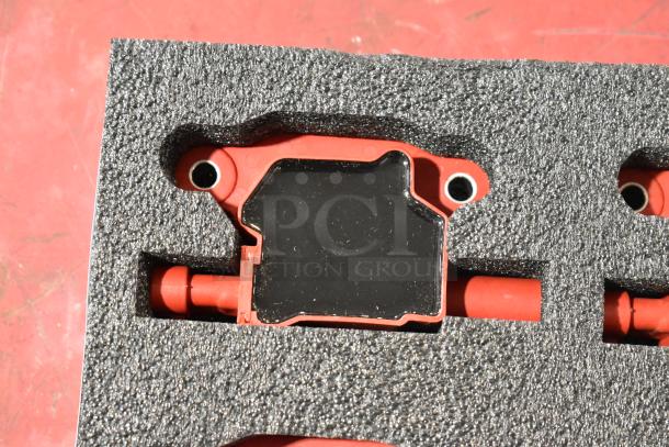 Lot of 4 red and black pieces in foam packaging. Components have a red base and black top, condition appears new.