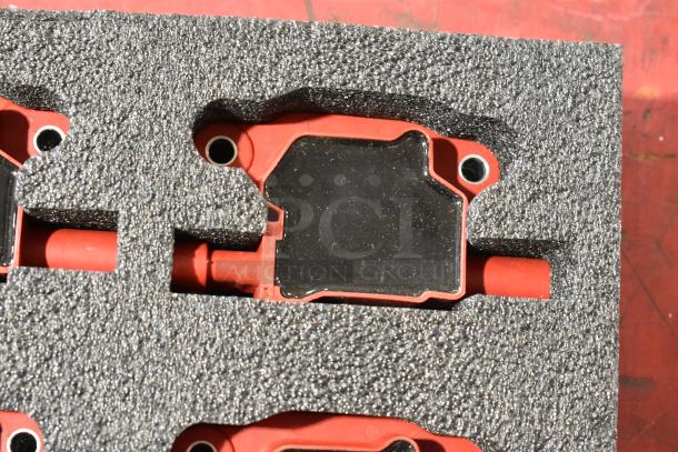 Lot of 4 red and black automotive components in foam packaging, new condition, featuring polished metal accents.