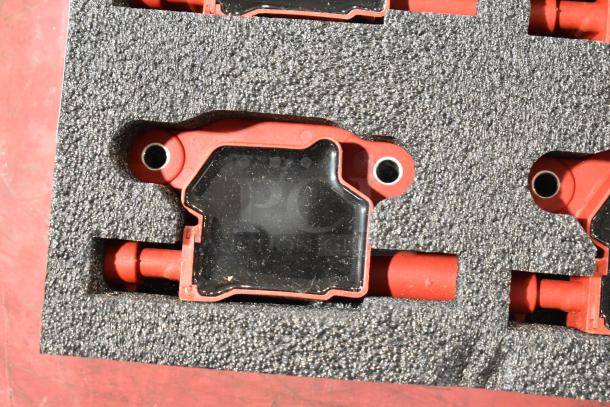 Lot of 4 red and black components in foam packaging, showing metallic connectors and sleek black covers.