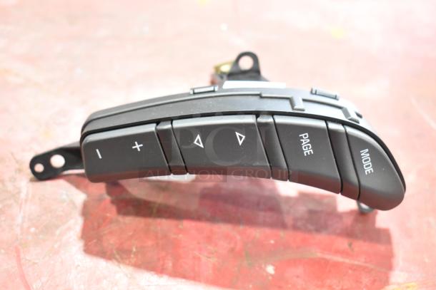 GM 20844868 switch with labeled buttons for volume, page, and mode, in excellent condition.