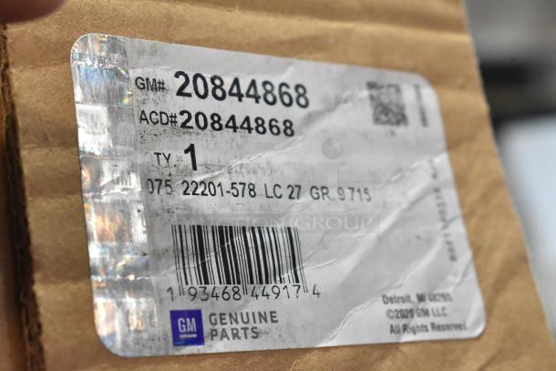 GM 20844868 switch label on cardboard, showing barcode and Genuine GM Parts. Part of auction with 4 various items.