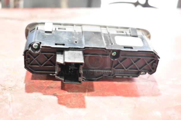 GM 20844868 switch, black plastic, shown on a workbench with visible connector pins. Visible GM label.