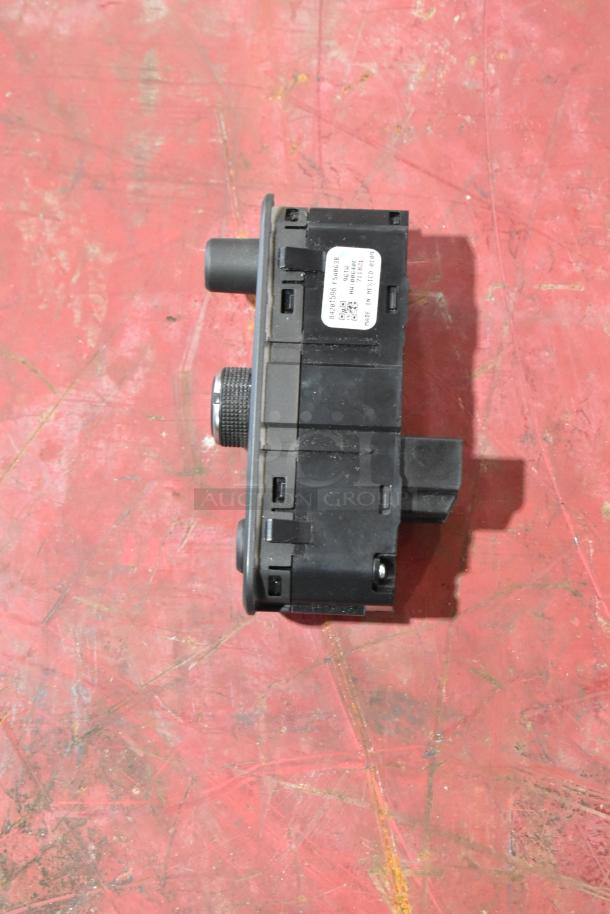 GM 20844868 switch on red background, black plastic housing, visible label with part number, good condition.
