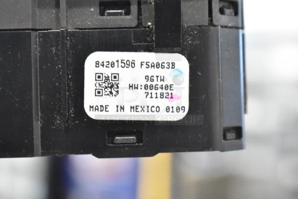 Close-up of a GM 20844868 switch with a label showing QR code and "Made in Mexico." Visible dust, moderate wear.