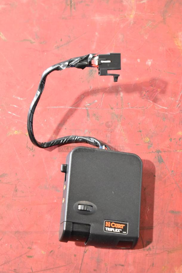 Curt Triflex brake controller with wiring, labeled in good condition.